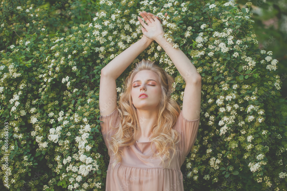 Attractiveyoung woman with blonde hair on spring nature background outdoors Attractiveyoung woman with blonde hair on spring nature background outdoors