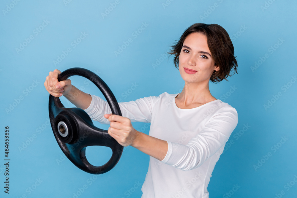 Photo of charming adorable business lady driving car ride to work wear white apparel isolated on blue color background Photo of charming adorable business lady driving car ride to work wear white apparel isolated on blue color background
