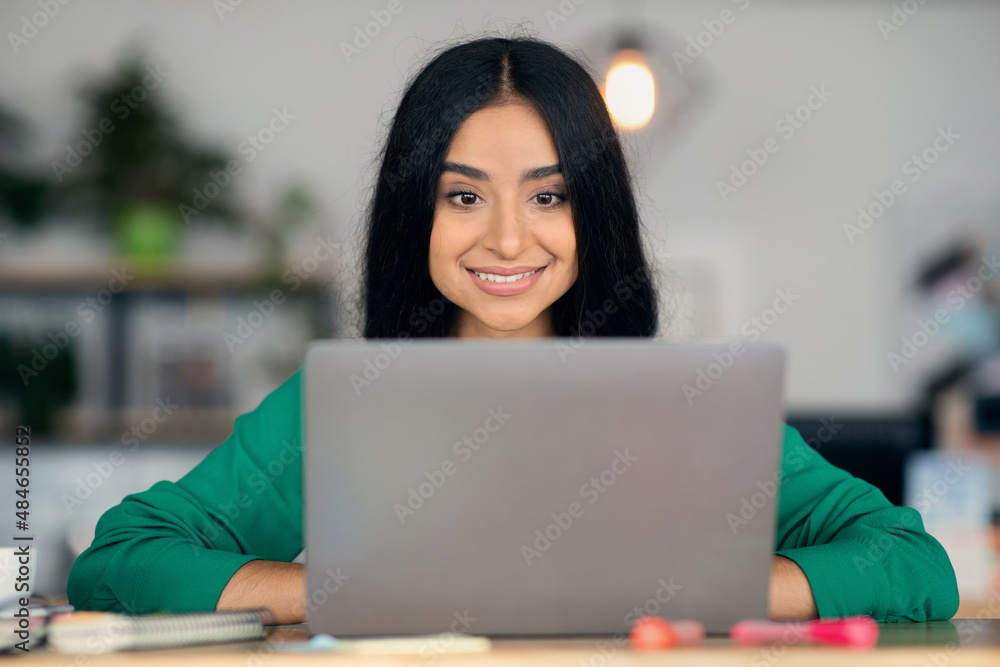 Closeup portrait of indian young woman freelancer working on laptop Closeup portrait of indian young woman freelancer working on laptop