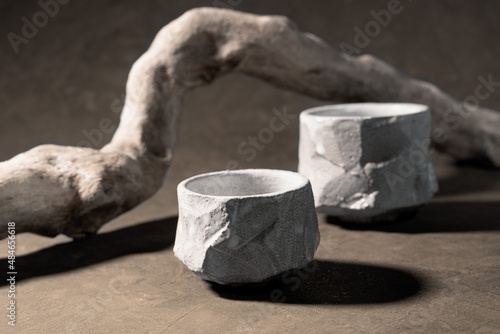 Two empty bowls-tyawan, handmade from Japanese-style ceramics. Wooden, textured, dry branch. Wabi sabi style, handcraft concept, handmade ceramics. photo
