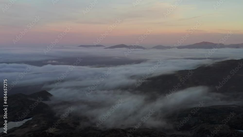 Dark aerial view of Snowdonia in Wales UK at sunrise with low cloud Dark aerial view of Snowdonia in Wales UK at sunrise with low cloud