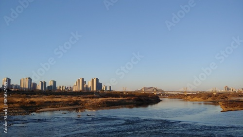 Fototapeta Naklejka Na Ścianę i Meble -  Sky, river, city, and bridge
