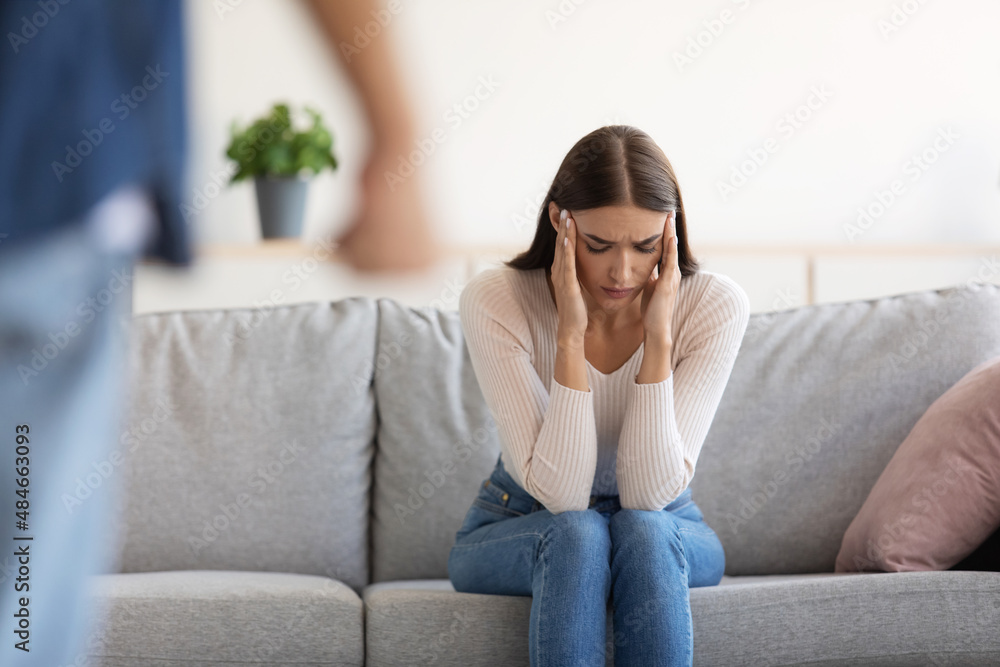Sad unhappy millennial caucasian wife afraid of her angry aggressive husband Sad unhappy millennial caucasian wife afraid of her angry aggressive husband
