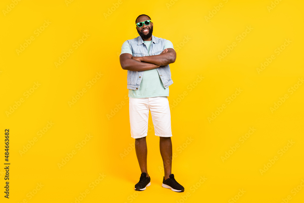 Fototapeta premium Full length body size view of attractive cheery guy hipster folded arms isolated over bright yellow color background