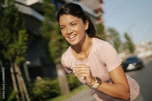 Fit athlete woman in sportswear outdoors. Young woman jogging outside.