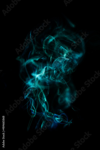 Fototapeta Naklejka Na Ścianę i Meble -  Green smoke pattern, beautiful puffs of smoke from cigarettes and hookah in the dark