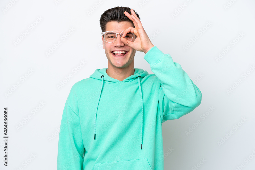 Young handsome caucasian man isolated on white bakcground showing ok sign with fingers Young handsome caucasian man isolated on white bakcground showing ok sign with fingers