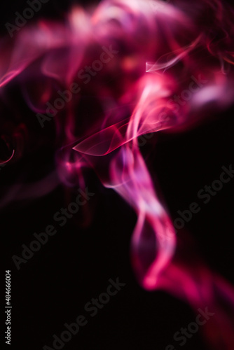 Pink and scarlet patterns of smoke from cigarettes and hookah, fumigation of a magical space