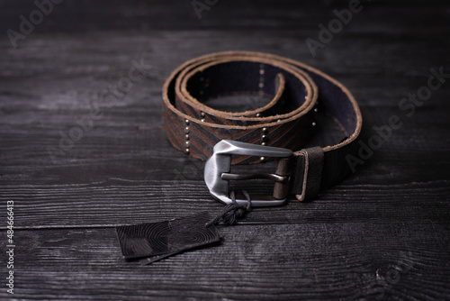 brown leather men's belt on a dark background