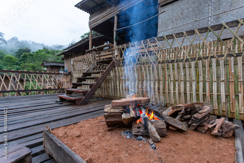 Bonfire on the courtyard in front of the wooden house for winter camping on the houses of hill tribes in Thailand hill tribe house in the forest Firewood and fireplaces are needed in the house.