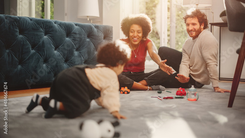 Obraz na płótnie Loving Mixed Race Family Playing with Toys with Adorable Baby Boy at Home on Living Room Floor