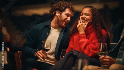 Loving Mixed Race Couple Sitting Together on an Outdoors Terrace on a Warm Summer Evening. Beautiful Caucasian Ginger Man and Black Woman with Afro Hair Relax on Weekend, Drink Vine
