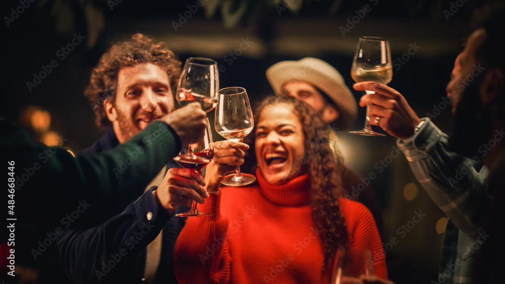 Group of Happy Multiethnic Friends are Having a Garden Outdoors Party on a Warm Evening. Men and Women Dance and Move to Trendy Music. People Drinking Wine and Enjoying Life on Weekend Night Out.