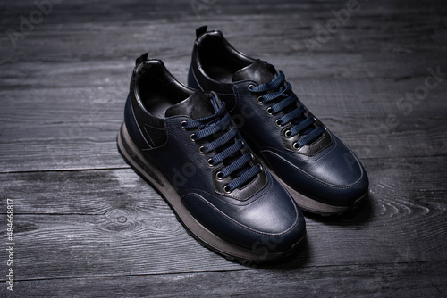 dark blue leather men's sneakers on a dark background