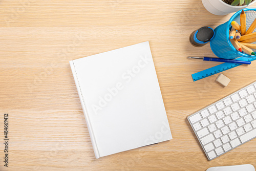 office stuff on a wooden table with office supplies and a cup of coffee  top view succulent. open notebook