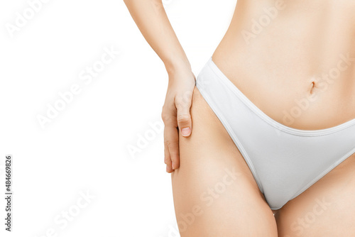Close up photo of slim woman in white panties touching hips