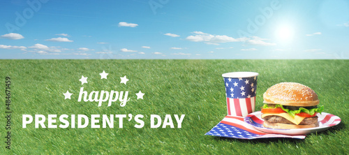Burger and drinks on green grass. Outdoor.USA flag. Happy presidents day. photo