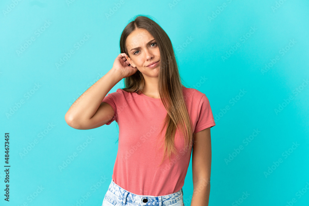 Young woman over isolated blue background having doubts Young woman over isolated blue background having doubts