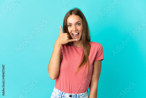 Young woman over isolated blue background making phone gesture. Call me back sign