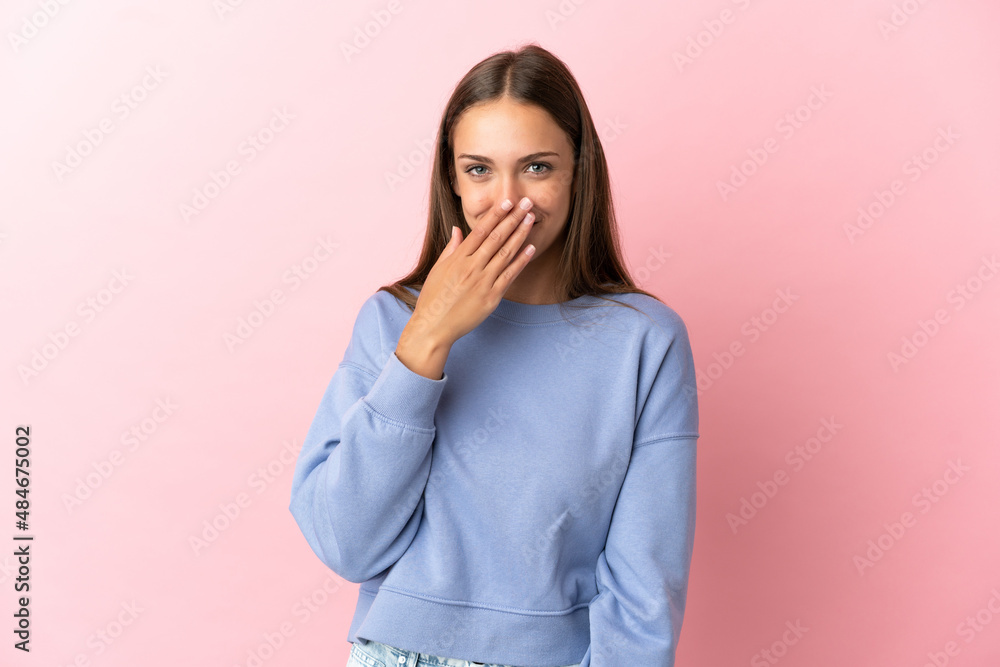 Young woman over isolated pink background happy and smiling covering mouth with hand Young woman over isolated pink background happy and smiling covering mouth with hand