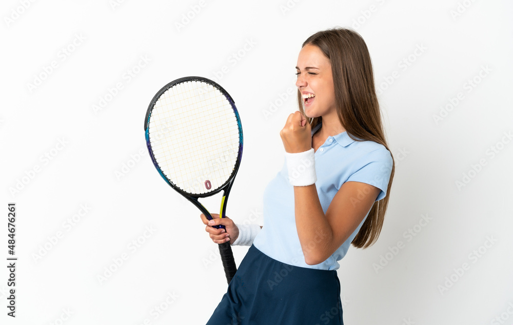 Young woman over isolated white background playing tennis and celebrating a victory Young woman over isolated white background playing tennis and celebrating a victory