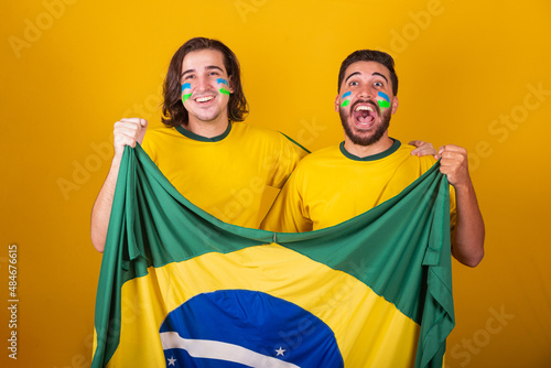 Brazilian friends, latin americans, diversity, cheering for brazil, world cup 2022, holding brazil flag, football, cheering and vibrating, screaming goal, joyful and happy photo