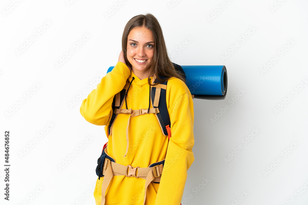 Young mountaineer woman with a big backpack over isolated white background laughing Young mountaineer woman with a big backpack over isolated white background laughing