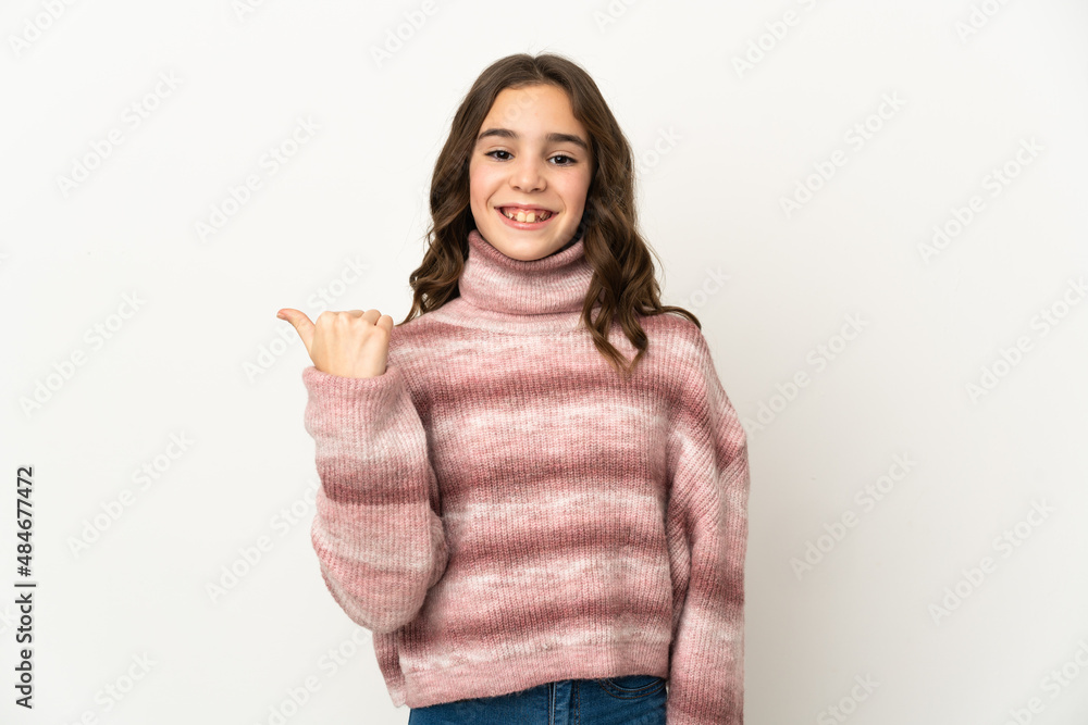 Little caucasian girl isolated on white background pointing to the side to present a product Little caucasian girl isolated on white background pointing to the side to present a product
