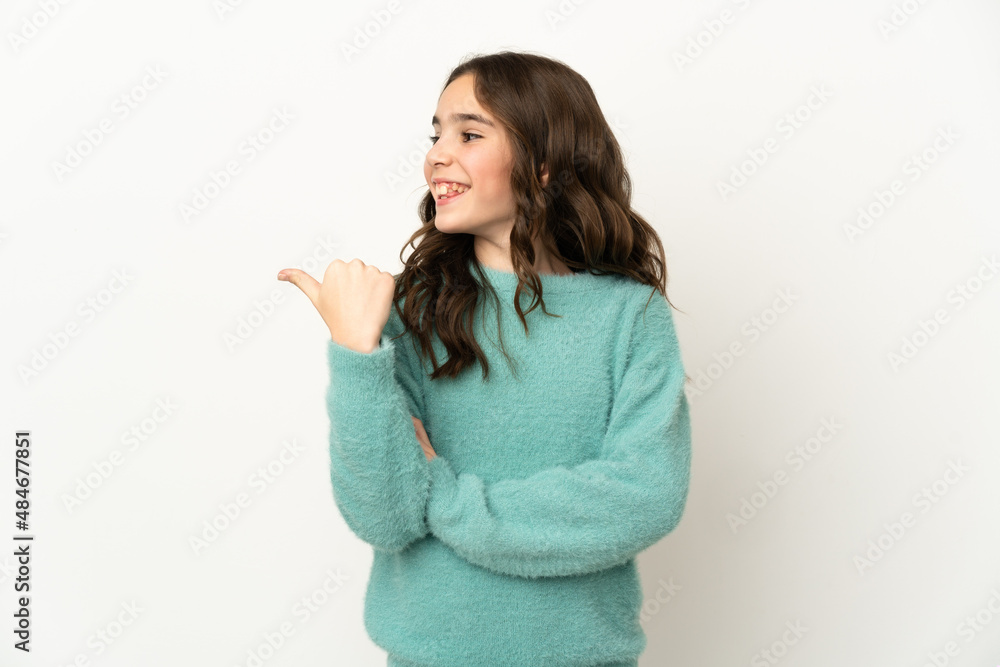 Little caucasian girl isolated on white background pointing to the side to present a product Little caucasian girl isolated on white background pointing to the side to present a product