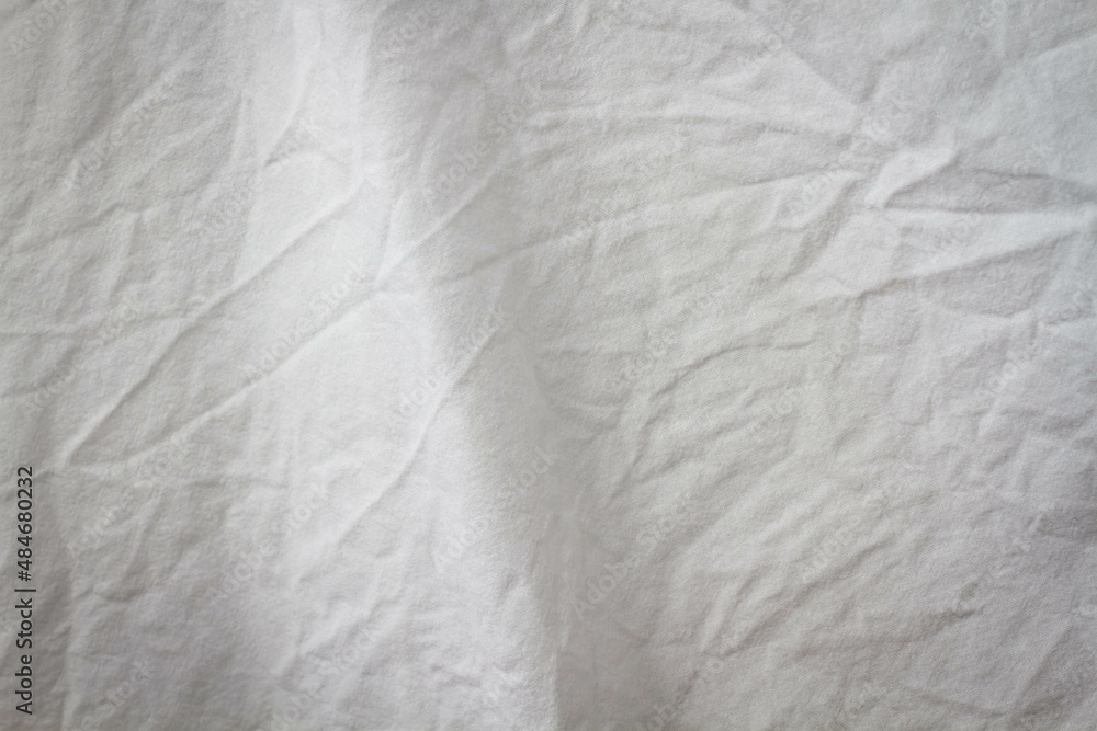 Wrinkled sheet. White fabric close-up. Burlap texture. Sheet on the bed. Wrinkled sheet. White fabric close-up. Burlap texture. Sheet on the bed.