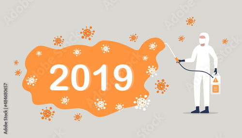 CAVID-19 coronavirus a worker in a protective suit sprays a disinfectant chemical to disinfect the viral pathogen.