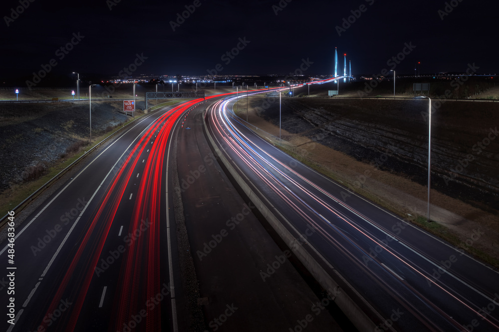Highway leading to the big bridge and lights from cars at night. Queensferry Crossing, Scotland, United Kingdom
