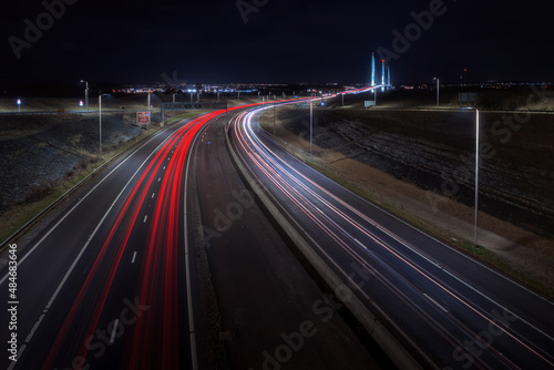 Highway leading to the big bridge and lights from cars at night. Queensferry Crossing, Scotland, United Kingdom