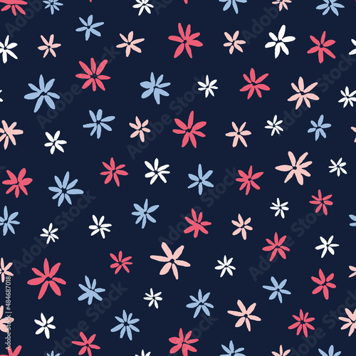 Cute multicolored ditsy seamless repeat pattern. Random placed, vector floral all over print on dark blue background.