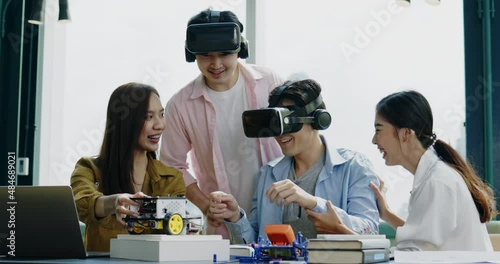 Group of Asian businessmen hold meeting to test VR glasses technology in co-working space. Collaboration of startup business team. learning innovation of meta verse technology of model electric car