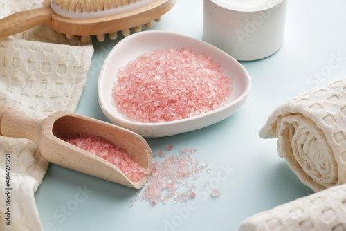 Pink bath salt, dry body massage brush, muslin towels. Body care. View from above.