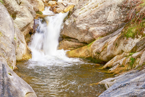 waterfall flowing into small stream bed