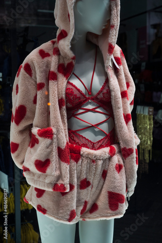 Closeup of sexy valentines day underwear and fluffy pyjama with printed hearts on mannequin in a fashion store showroom