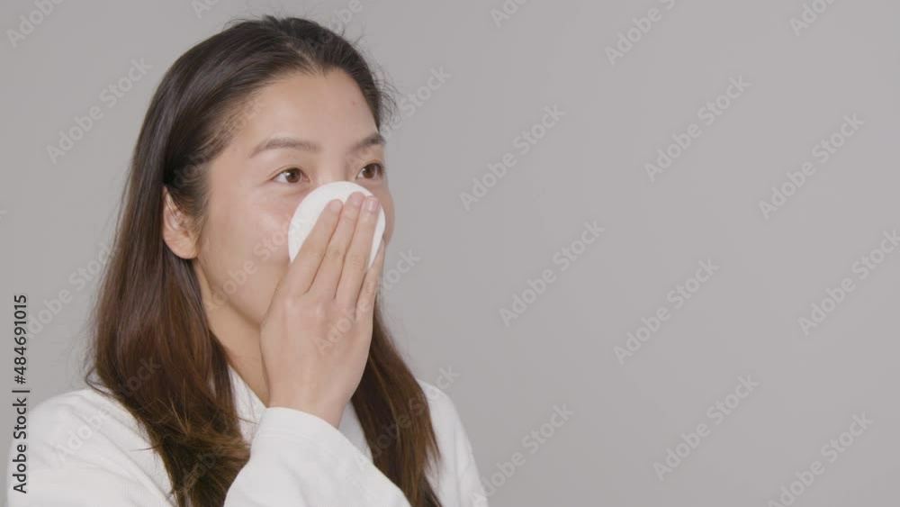 Mid Shot of Young Woman Taking off Makeup Mid Shot of Young Woman Taking off Makeup