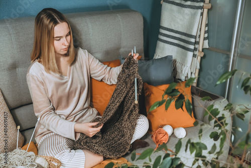 Knitting.Girl knitting at home.Handmade zero waste,upcycling,New small business employment opportunity concept.Hobby knitting and needlework for mental health.Knitted background,eco friendly knitting photo