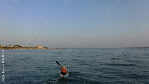 Man paddling a kayak in the sea