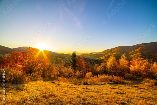Sun sets behind forestry mountains in highland in autumn © YouraPechkin