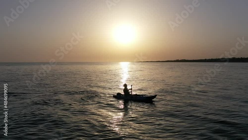 Man paddling a kayak in the sea