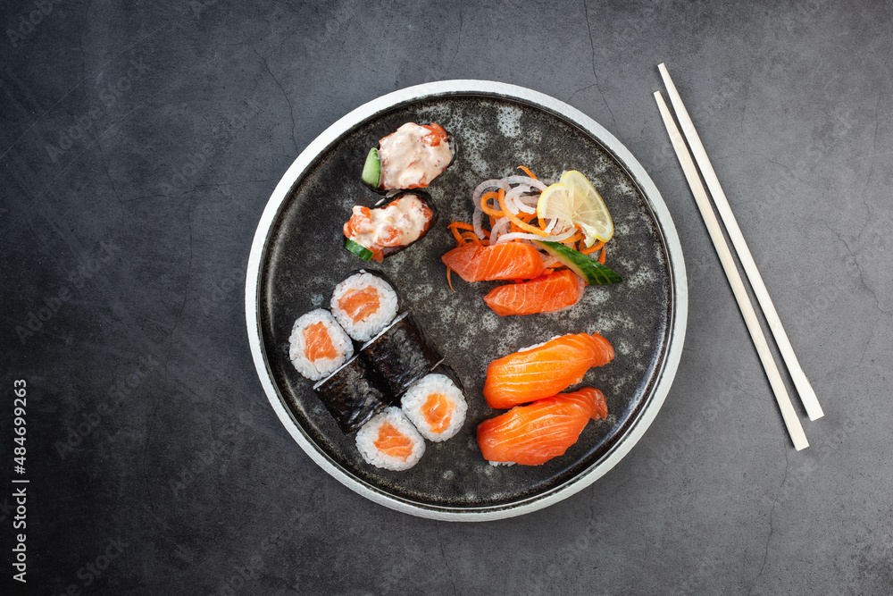 Assorted sushi nigiri and maki with salmon. Big set on plate Assorted sushi nigiri and maki with salmon. Big set on plate