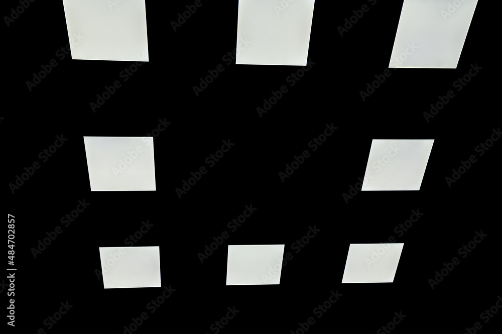 White squares on a black background. White square led light on a black background. Beautiful background White squares on a black background. White square led light on a black background. Beautiful background