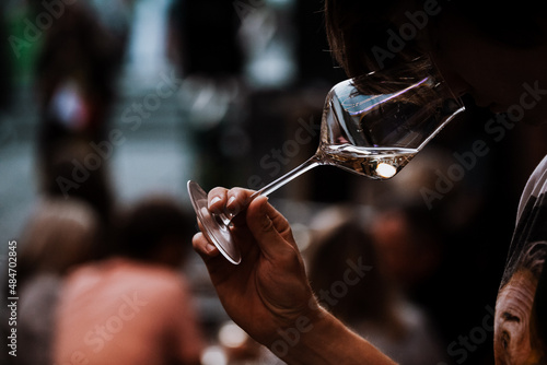 wine glass in the male sommelier's hand. Wine bar or winery. degustation.