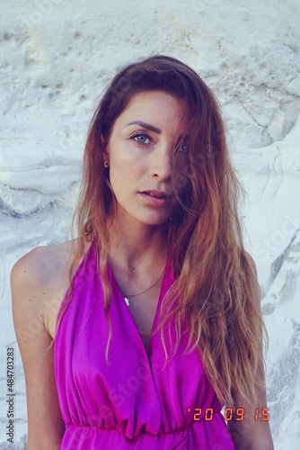 woman in a pink dress on the beach in milos greece model shooting 