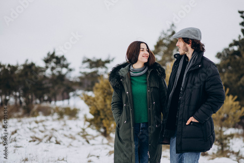 Couple together in winter park having fun