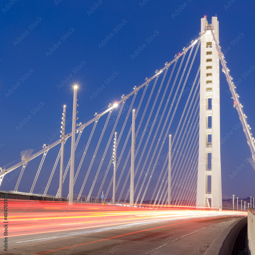Obraz premium Car light trails painting the Bay Bridge New Eastern Span connecting San Francisco and Oakland.