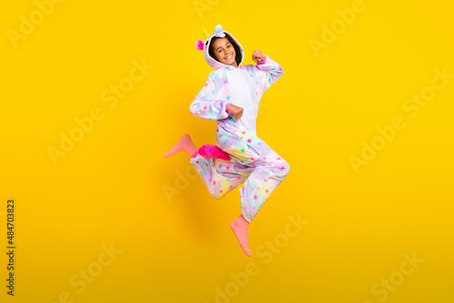 Full body profile side photo of young excited black girl go jump sleepover hood isolated over yellow color background